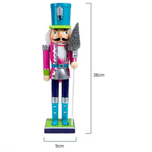 Load image into Gallery viewer, Neon Costume Nutcracker Soldiers by Allthingscurated.  These Nutcracker figures sport a psychedelic look with electric shades of Neon Blue, Green and Pink which is a daring and bold twist from the usual classic-style Nutcracker design. Their eye-catching colors and design will create a show-stopping look for your Christmas decor, making it truly unforgettable. Featured here is the Neon Pink Soldier measuring 38cm or 14.8 inches in height and 9cm or 3.5 inches in width.
