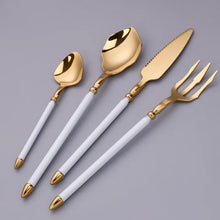 Load image into Gallery viewer, Neptune 4-piece Colored Handle Luxury Flatware Set by Allthingscurated beautifully blends mythical design with modern construction. Made from high-quality 18/10 stainless steel with a sleek mirror polishing for a modern look. Inspired by Poseidon’s Trident, the dinner fork is expertly shaped to resemble the 3-pronged spear. The set consists of a dinner spoon, dinner fork, dinner knife and a small spoon. Featured here is gold with white handle set.
