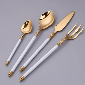 Neptune 4-piece Colored Handle Luxury Flatware Set by Allthingscurated beautifully blends mythical design with modern construction. Made from high-quality 18/10 stainless steel with a sleek mirror polishing for a modern look. Inspired by Poseidon’s Trident, the dinner fork is expertly shaped to resemble the 3-pronged spear. The set consists of a dinner spoon, dinner fork, dinner knife and a small spoon. Featured here is gold with white handle set.