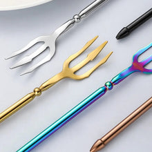 Load image into Gallery viewer, Neptune 4-piece Flatware Set by Allthingscurated beautifully blends mythical design with modern construction. Made from high-quality 18/10 stainless steel with a sleek mirror polishing for a modern look. Inspired by Poseidon’s Trident, the dinner fork is expertly shaped to resemble the 3-pronged spear. Unique and elegant, the place setting comes in silver, gold, rose gold, black and colorful rainbow and each set consists of a dinner spoon, dinner fork, dinner knife and a small spoon.
