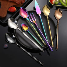 Load image into Gallery viewer, Neptune 4-piece Flatware Set by Allthingscurated beautifully blends mythical design with modern construction. Made from high-quality 18/10 stainless steel with a sleek mirror polishing for a modern look. Inspired by Poseidon’s Trident, the dinner fork is expertly shaped to resemble the 3-pronged spear. Unique and elegant, the place setting comes in silver, gold, rose gold, black and colorful rainbow and each set consists of a dinner spoon, dinner fork, dinner knife and a small spoon.
