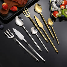 Load image into Gallery viewer, Neptune 4-piece Flatware Set by Allthingscurated beautifully blends mythical design with modern construction. Made from high-quality 18/10 stainless steel with a sleek mirror polishing for a modern look. Inspired by Poseidon’s Trident, the dinner fork is expertly shaped to resemble the 3-pronged spear. Unique and elegant, the place setting comes in silver, gold, rose gold, black and colorful rainbow and each set consists of a dinner spoon, dinner fork, dinner knife and a small spoon.
