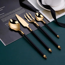 Load image into Gallery viewer, Neptune 4-piece Colored Handle Luxury Flatware Set by Allthingscurated beautifully blends mythical design with modern construction. Made from high-quality 18/10 stainless steel with a sleek mirror polishing for a modern look. Inspired by Poseidon’s Trident, the dinner fork is expertly shaped to resemble the 3-pronged spear. This place setting comes in Gold with either black, white, turquoise blue and green handle. Each set consists of a dinner spoon, dinner fork, dinner knife and a small spoon.
