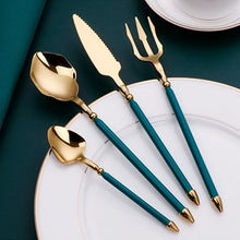 Load image into Gallery viewer, Neptune 4-piece Colored Handle Luxury Flatware Set by Allthingscurated beautifully blends mythical design with modern construction. Made from high-quality 18/10 stainless steel with a sleek mirror polishing for a modern look. Inspired by Poseidon’s Trident, the dinner fork is expertly shaped to resemble the 3-pronged spear. This place setting comes in Gold with either black, white, turquoise blue and green handle. Each set consists of a dinner spoon, dinner fork, dinner knife and a small spoon.
