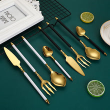 Load image into Gallery viewer, Neptune 4-piece Colored Handle Luxury Flatware Set by Allthingscurated beautifully blends mythical design with modern construction. Made from high-quality 18/10 stainless steel with a sleek mirror polishing for a modern look. Inspired by Poseidon’s Trident, the dinner fork is expertly shaped to resemble the 3-pronged spear. This place setting comes in Gold with either black, white, turquoise blue and green handle. Each set consists of a dinner spoon, dinner fork, dinner knife and a small spoon.
