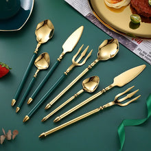 Load image into Gallery viewer, Neptune 4-piece Colored Handle Luxury Flatware Set by Allthingscurated beautifully blends mythical design with modern construction. Made from high-quality 18/10 stainless steel with a sleek mirror polishing for a modern look. Inspired by Poseidon’s Trident, the dinner fork is expertly shaped to resemble the 3-pronged spear. This place setting comes in Gold with either black, white, turquoise blue and green handle. Each set consists of a dinner spoon, dinner fork, dinner knife and a small spoon.
