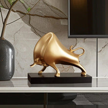 Load image into Gallery viewer, The Oscar Bull Sculpture by Allthingscurated spots an abstract and contemporary design in a matte gold finish. This stunning piece makes the perfect gift for those born under the zodiac ox sign and Taurus. It not only serves as a beautiful display but also adds a touch of personality. 
