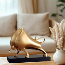 Load image into Gallery viewer, The Oscar Bull Sculpture by Allthingscurated spots an abstract and contemporary design in a matte gold finish. This stunning piece makes the perfect gift for those born under the zodiac ox sign and Taurus. It not only serves as a beautiful display but also adds a touch of personality. 
