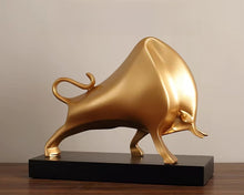 Load image into Gallery viewer, The Oscar Bull Sculpture by Allthingscurated spots an abstract and contemporary design in a matte gold finish. This stunning piece makes the perfect gift for those born under the zodiac ox sign and Taurus. It not only serves as a beautiful display but also adds a touch of personality. 
