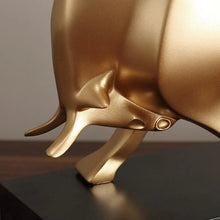 Load image into Gallery viewer, The Oscar Bull Sculpture by Allthingscurated spots an abstract and contemporary design in a matte gold finish. This stunning piece makes the perfect gift for those born under the zodiac ox sign and Taurus. It not only serves as a beautiful display but also adds a touch of personality. 
