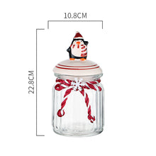 Load image into Gallery viewer, Christmas Festive Storage Jars by Allthingscurated are the perfect jars to keep all your festive treats fresh and delicious. The jars are airtight and each jar is topped with a ceramic lid decorated with a Santa Claus, Christmas Tree, Penguin, Gnome or Fox. Comes in 2 sizes with capacity of 300ml or 10 ounce and 1000ml or 34 ounce. Featured here is a large Penguin jar.
