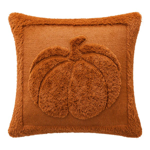 Brown textured pillow with a pumpkin design on a white background. Cozy living room with a sofa adorned with pumpkin-themed pillows and a yellow blanket. The Velour Pumpkin Cushion Cover by Allthingscurated is a beautiful way to bring the warmth of fall into your home. With its elegant tufted pumpkin design and soft velour fabric, it offers both comfort and style. Perfect for autumn and Thanksgiving, this decorative pillow adds a cozy, inviting touch to any space.