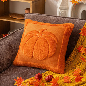 Orange pillow with pumpkin design on a brown couch, surrounded by autumn decorations. Cozy living room with a sofa adorned with pumpkin-themed pillows and a yellow blanket. The Velour Pumpkin Cushion Cover by Allthingscurated is a beautiful way to bring the warmth of fall into your home. With its elegant tufted pumpkin design and soft velour fabric, it offers both comfort and style. Perfect for autumn and Thanksgiving, this decorative pillow adds a cozy, inviting touch to any space.