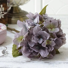 Load image into Gallery viewer, Silk Hydrangeas by Allthingscurated are made of premium quality silk that feature realistic looking flowers that are perfect for home décor and wedding venue decoration. Create a stunning display with 8 lovely colors available and add a touch of beauty and elegance to any space.  Featured here is the color Purplish Gray.
