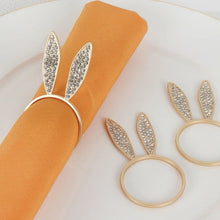 Load image into Gallery viewer, These sparkling Bunny Ear Napkin Rings (set of 6) by Allthingscurated add a cute and whimsical touch to your Easter table setting. Made of metal and encrusted with rhinestones, they come in gold, silver, and rose gold. Elevate your dining experience with these charming and sparkly napkin rings.
