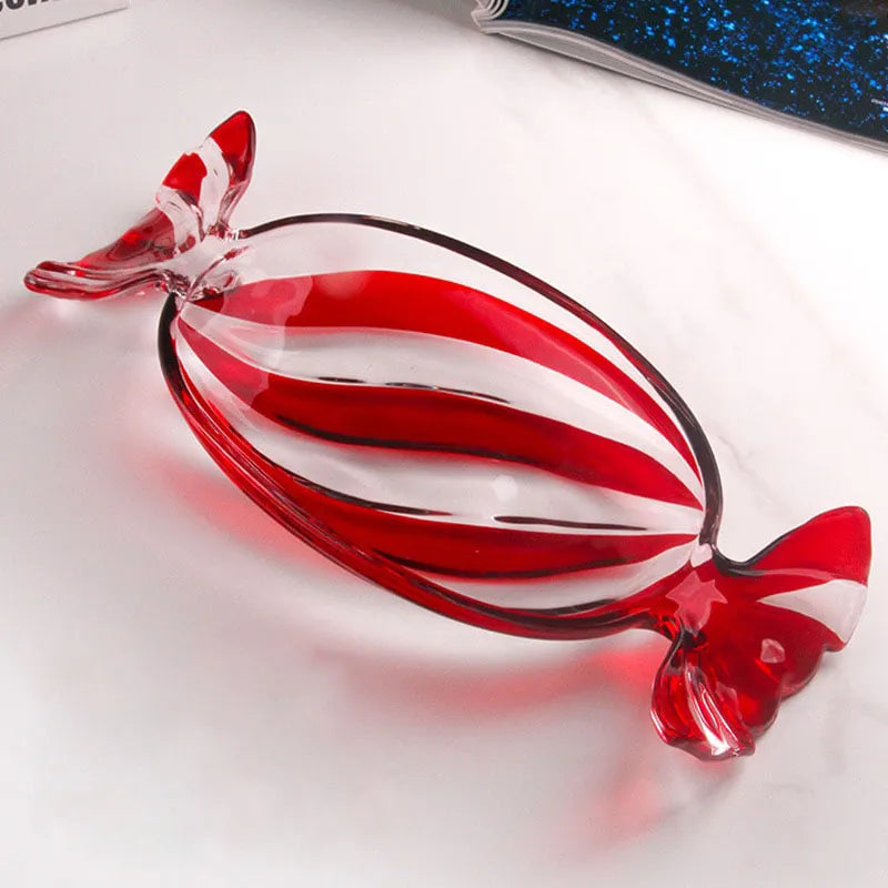 Peppermint Candy Glass Dish by Allthingscurated is a charming and beautiful dish inspired by the signature red and white peppermint candy cane synonymous with Christmas. Perfect as a serveware for your festive treats and also functional as a decorative tray for your coffee table. Measuring 34cm or 13 inches long, 15cm or 6 inches wide and 4cm or 1.6 inches high. Featured here is a dish with red stripes.