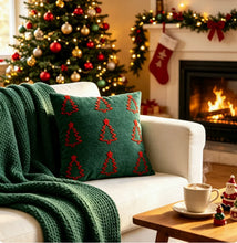 Load image into Gallery viewer, A white sofa with a green knit throw and a dark green pillow featuring embroidered red Christmas trees, set in front of a fireplace with holiday home decoration.
