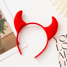 Load image into Gallery viewer, Horn Shape Headband by Allthingscurated features trendy, three-dimensional horns that is fun and perfect for elevating your Halloween party look. This accessory is perfect for adding a playful touch to your costume and make a statement at any Halloween party. Comes in 3 colors. Featured here is the Red headband.
