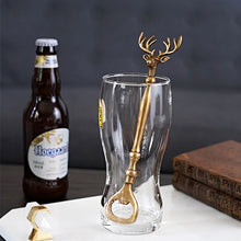 Load image into Gallery viewer, Brass Reindeer Bottle Opener by Allthingscurated.  Crafted from brass and designed with a long handle and an ornamental reindeer head—it is an eye-catching bar tool and charming accessory for Christmas and beyond.
