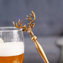 Load image into Gallery viewer, Brass Reindeer Bottle Opener by Allthingscurated.  Crafted from brass and designed with a long handle and an ornamental reindeer head—it is an eye-catching bar tool and charming accessory for Christmas and beyond.
