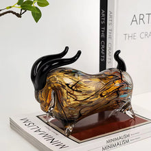 Load image into Gallery viewer, Glass bull sculpture on a stack of books. Rex Decorative Bull by Allthingscurated are meticulously handmade from high quality glass. Comes in three striking finishes—an all-all black edition or two-tone variants featuring bold graphic elements. Rex brings contemporary flair and bold energy to any room. More than décor, it’s an ideal gift for those born under the Ox zodiac and Taurus sign.
