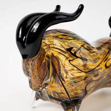 Load image into Gallery viewer, Decorative bull sculptures on books with a candle against a textured white wall. Rex Decorative Bull by Allthingscurated are meticulously handmade from high quality glass. Comes in three striking finishes—an all-all black edition or two-tone variants featuring bold graphic elements. Rex brings contemporary flair and bold energy to any room. More than décor, it’s an ideal gift for those born under the Ox zodiac and Taurus sign. Here shows a close up shot of the bull head with black horns.
