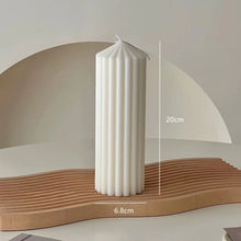 Load image into Gallery viewer, White Ribbed Column Candles by Allthingscurated are made of 100% soy wax. Hand crafted with vertical ridged pattern for texture, these candles are scented with the sweet smell of white rose. Available in 2 sizes. Featured here is the tall candle.
