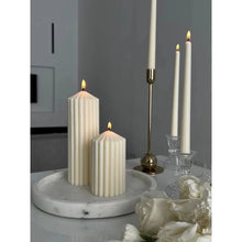 Load image into Gallery viewer, White Ribbed Column Candles by Allthingscurated are made of 100% soy wax. Hand crafted with vertical ridged pattern for texture, these candles are scented with the sweet smell of white rose. Available in 2 sizes.
