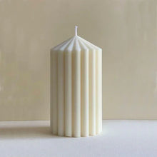 Load image into Gallery viewer, White Ribbed Column Candles by Allthingscurated are made of 100% soy wax. Hand crafted with vertical ridged pattern for texture, these candles are scented with the sweet smell of white rose. Available in 2 sizes.
