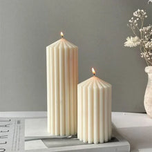 Load image into Gallery viewer, White Ribbed Column Candles by Allthingscurated are made of 100% soy wax. Hand crafted with vertical ridged pattern for texture, these candles are scented with the sweet smell of white rose. Available in 2 sizes.
