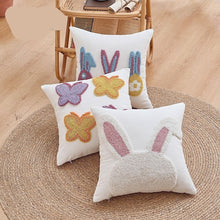 Load image into Gallery viewer, Decorative pillows with embroidered designs on a wooden floor. Spring Melody Embroidered Cushion Covers by Allthingscurated feature charming seasonal details to transition your home into Spring and Easter effortlessly. Each cover showcases meticulous embroidery to add depth and visual interest to your sofa and furniture.
