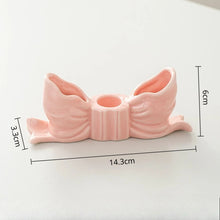 Load image into Gallery viewer, Pink bow candle holder with measurements on a white background. Fashion Bow Candle Holder by Allthingscurated spots a distinctive knot design, beautiful yet practical. Perfect for wedding celebrations, home styling, or to infuse warmth and romance into any living space. Available in three colors and 2 sizes.
