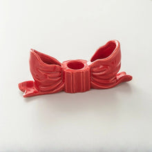 Load image into Gallery viewer, Fashion Bow Candle Holder by Allthingscurated spots a distinctive knot design, beautiful yet practical. Perfect for wedding celebrations, home styling, or to infuse warmth and romance into any living space. Available in three colors and 2 sizes. Shown here is a small size Red bow candle holder on a white background.
