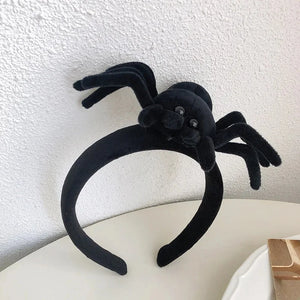 Featuring 3 cute designs, Plush Halloween Headbands by Allthingscurated blend comfort with style. They add a charming touch to your costume and create joyful photo moments to capture the festive spirit.
Seen here is Black spider design headband on a white surface.
