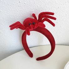 Load image into Gallery viewer, Featuring 3 cute designs, Plush Halloween Headbands by Allthingscurated blend comfort with style. They add a charming touch to your costume and create joyful photo moments to capture the festive spirit.
Seen here is the Red spider design headband on a white surface with a white wall background.
