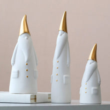Load image into Gallery viewer, Not your typical jolly Santa Clauses with a plush red suit and rounded belly, this Nordic Santa Claus Figurines Set by Allthingscurated featured 3 porcelain figures of Santa Claus dressed in long white gown and a gold pointed hat. With subtle, understated elegance, they are perfect decoration to add to your Christmas collection to create an enchanting display. Figurines come in 3 different heights of 15cm, 20cm and 23cm or 6 inches, 7.8 inches and 9 inches.
