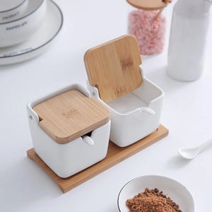 Ceramic Seasoning Storage Jars by Allthingscurated are the perfect storage solution to keep your herbs, seasonings and spices. Made of durable ceramic with a sustainable bamboo flip lid for easy access during cooking. These jars are not only functional but also environmentally friendly. Comes with a bamboo tray and ceramic spoons.