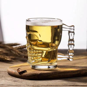 Skull Beer Mug by Allthingscurated blends functionality with style. Made with thickened glass with a heavy bottom for stability, it spots a fun, cool skull shape design that is ideal for Halloween or everyday use. The large capacity is perfect for beer or any beverage. Add this must-have mug to your drinkware collection and be ready for any gatherings or house parties.