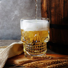 Load image into Gallery viewer, Skull Beer Mug by Allthingscurated blends functionality with style. Made with thickened glass with a heavy bottom for stability, it spots a fun, cool skull shape design that is ideal for Halloween or everyday use. The large capacity is perfect for beer or any beverage. Add this must-have mug to your drinkware collection and be ready for any gatherings or house parties.
