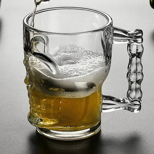 Skull Beer Mug by Allthingscurated blends functionality with style. Made with thickened glass with a heavy bottom for stability, it spots a fun, cool skull shape design that is ideal for Halloween or everyday use. The large capacity is perfect for beer or any beverage. Add this must-have mug to your drinkware collection and be ready for any gatherings or house parties.