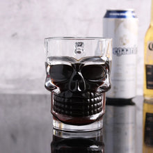 Load image into Gallery viewer, Skull Beer Mug by Allthingscurated blends functionality with style. Made with thickened glass with a heavy bottom for stability, it spots a fun, cool skull shape design that is ideal for Halloween or everyday use. The large capacity is perfect for beer or any beverage. Add this must-have mug to your drinkware collection and be ready for any gatherings or house parties.
