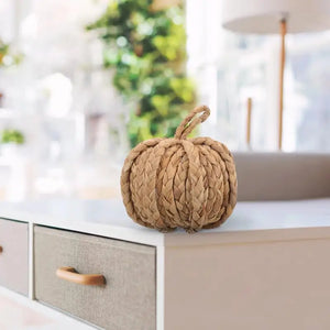 This Woven Straw Pumpkin by Allthingscurated is hand-woven with natural hyacinth straw. It is the perfect ornament to complement your autumn aesthetic and create a cozy and warm touch to any space.