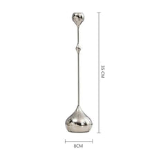 Load image into Gallery viewer, Lumea Silver Candle Holders by Allthingscurated feature a striking trio of sculptural pieces that blend contemporary design with timeless elegance. Each holder features a distinctive water droplet base that anchors a sleek, minimalist silhouette, creating an art deco-inspired statement on its own. this set makes an exceptional wedding gift for couples seeking sophisticated home décor that transcends occasion. Tall candle holder Design A with small droplet at the top featured here with measurements.

