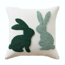 Load image into Gallery viewer, Spring Melody Embroidered Cushion Covers by Allthingscurated feature charming seasonal details to transition your home into Spring and Easter effortlessly. Each cover showcases meticulous embroidery to add depth and visual interest to your sofa and furniture. Design here featured two bunnies in contrasting colors of dark and light green against 45 by 45cm or 15.6 by 15.6 inches white cover.
