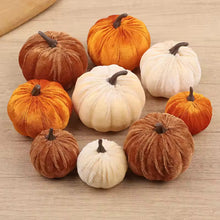 Load image into Gallery viewer, A set of nine plush velvet pumpkins in various sizes and colors, including shades of orange, brown, and cream, arranged on a light wood surface.
