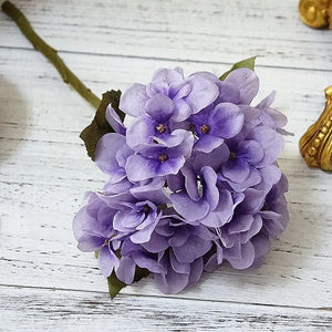 Silk Hydrangeas by Allthingscurated are made of premium quality silk that feature realistic looking flowers that are perfect for home décor and wedding venue decoration. Create a stunning display with 8 lovely colors available and add a touch of beauty and elegance to any space.  Featured here is the color Violet.