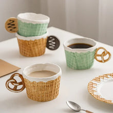 Load image into Gallery viewer, The Waffle Cup and Plate collection by Allthingscurated features a charming waffle pattern and whimsical biscuit design that will bring a smile to your breakfast. Each piece is hand painted on porcelain. Perfect for breakfast and tea time. Makes a great gift for any occasion. Cup and plate each comes in 4 designs to choose from.
