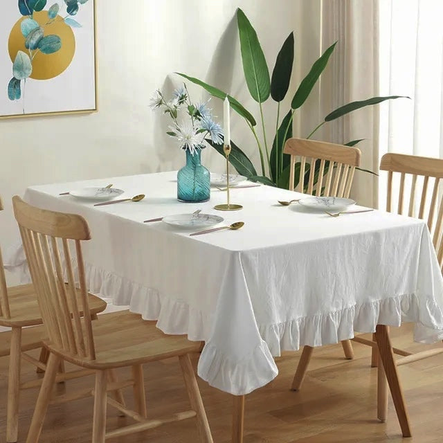 Introducing Ruffled Cotton Tablecloth by Allthingscurated. Made from 100% cotton, our tablecloth exudes French country charm with its romantic, frilly ruffles. With the perfect balance of decorative and laid-back, they have a welcoming and comforting vibe. Available in 8 solid colors. Featured here is the white tablecloth.
