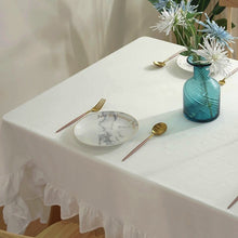 Load image into Gallery viewer, Introducing Ruffled Cotton Tablecloth by Allthingscurated. Made from 100% cotton, our tablecloth exudes French country charm with its romantic, frilly ruffles. With the perfect balance of decorative and laid-back, they have a welcoming and comforting vibe. Available in 8 solid colors.
