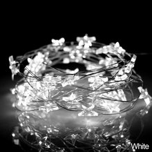 Load image into Gallery viewer, Mini Stars LED Fairy Lights by Althingscurated. Create a cozy and festive atmosphere with these decorative lights that offer a warm, tinkling glow. These mini stars are attached to silver wire that is bendable and easy to manipulate so you can fit them into tiny spaces or wrap around objects to enhance your favorite decorations.  Comes in 6 different lengths from 1 meters to 6 meters or 39 to 236 inches. Available in warm white or white lights. Featured here is white light.
